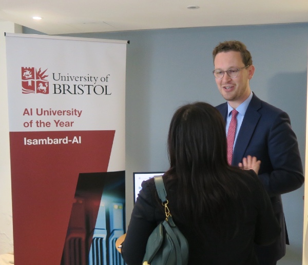Darren Jones MP stands in front of a banner showing the University of Bristol logo and Isambard-AI